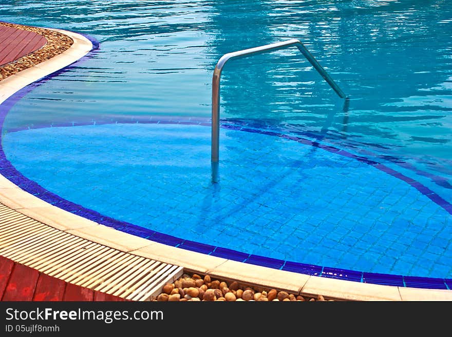 Luxury Resort Swimming Pool low angle on curved edge of a luxury resort swimming pool. Luxury Resort Swimming Pool low angle on curved edge of a luxury resort swimming pool