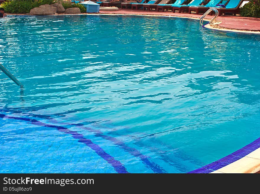 Luxury Resort Swimming Pool low angle on curved edge of a luxury resort swimming pool. Luxury Resort Swimming Pool low angle on curved edge of a luxury resort swimming pool