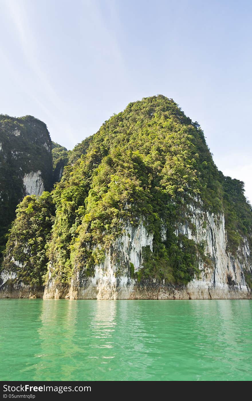 Beautiful high mountains and green river in the morning at Ratchaprapha Dam, Khao Sok National Park, Surat Thani Province, Thailand ( Guilin of Thailand ). Beautiful high mountains and green river in the morning at Ratchaprapha Dam, Khao Sok National Park, Surat Thani Province, Thailand ( Guilin of Thailand )