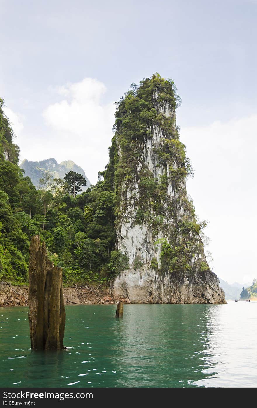 Beautiful high mountains and green river in the morning at Ratchaprapha Dam, Khao Sok National Park, Surat Thani Province, Thailand ( Guilin of Thailand ). Beautiful high mountains and green river in the morning at Ratchaprapha Dam, Khao Sok National Park, Surat Thani Province, Thailand ( Guilin of Thailand )