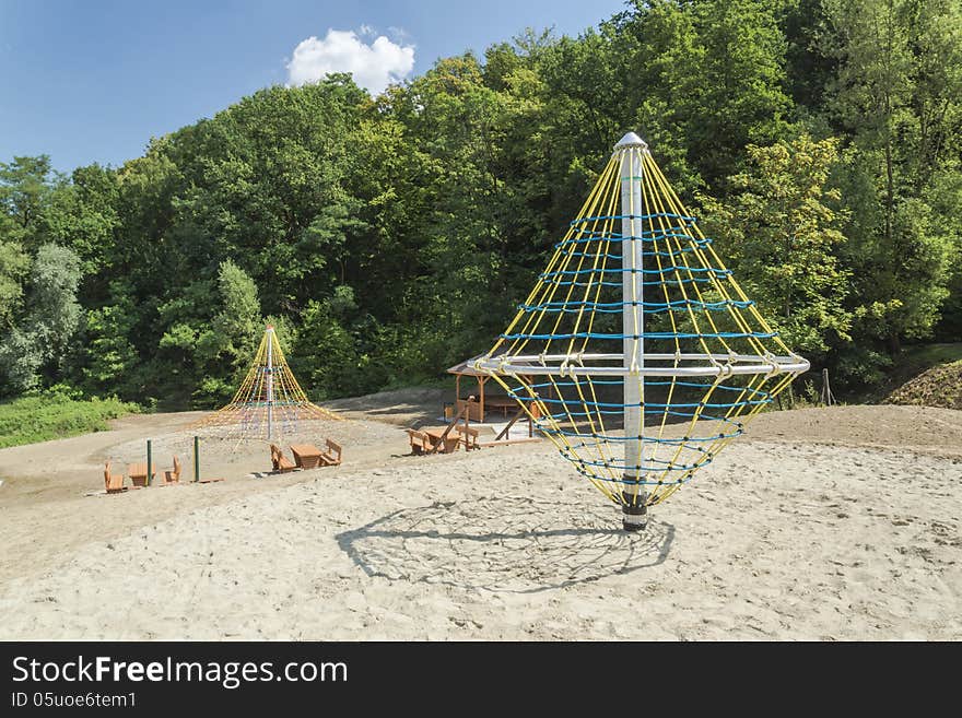 A colourful children playground equipment. In park in the little city.