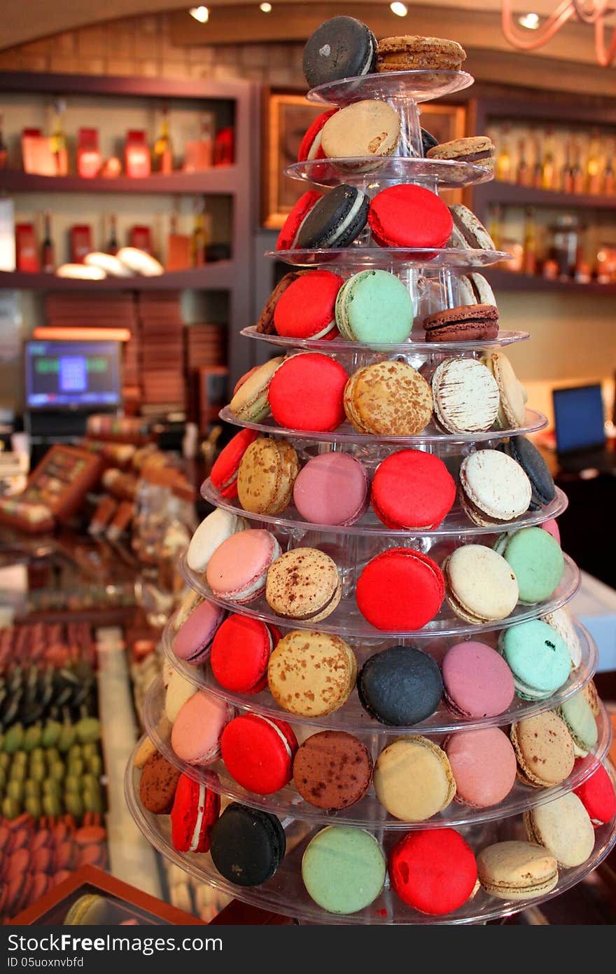 Fir-shaped arrangement made ​​delicious cookies and colored macaroons in market. Fir-shaped arrangement made ​​delicious cookies and colored macaroons in market.