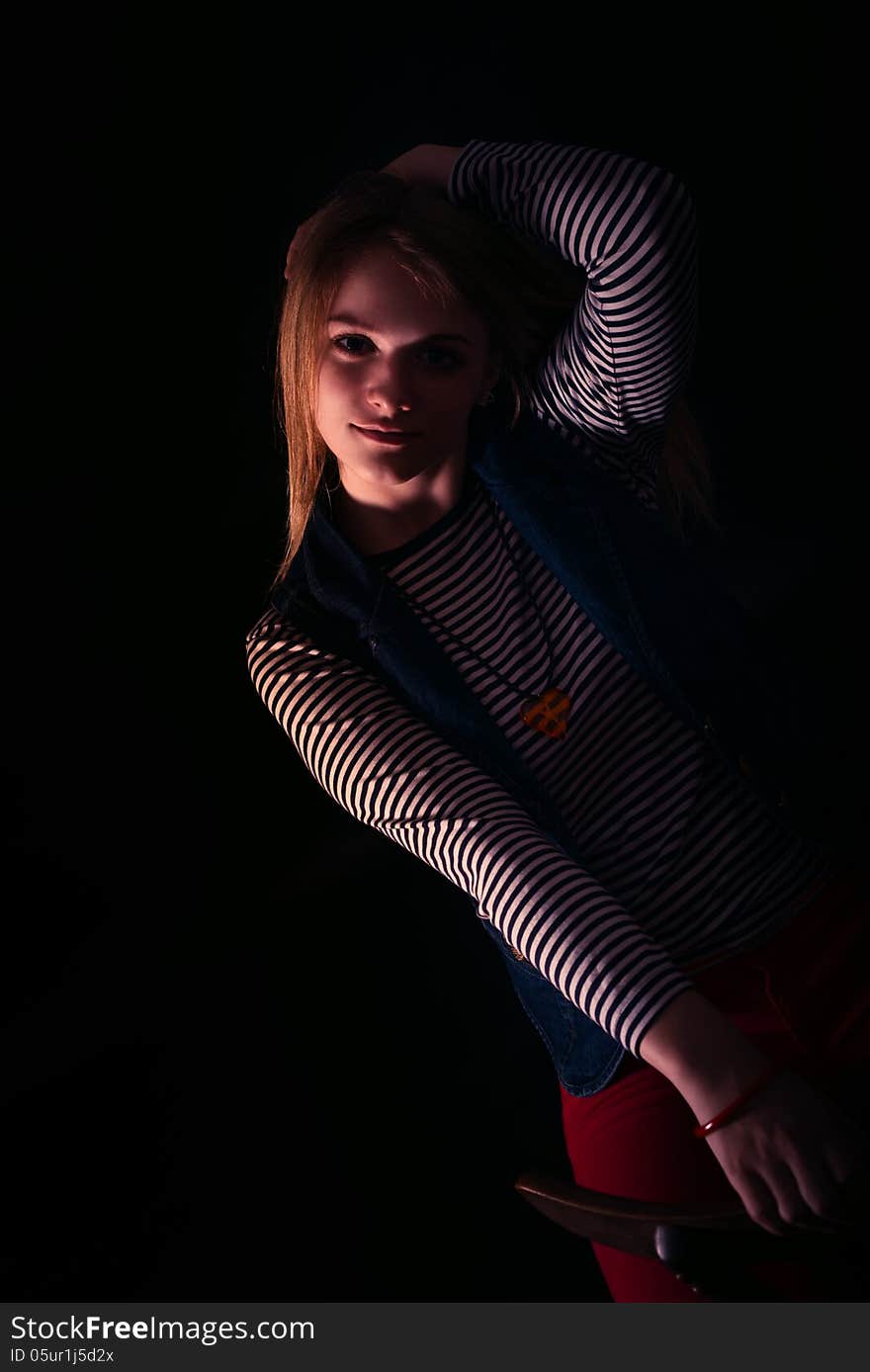 Portrait of beautiful thoughtful girl close up in the dark