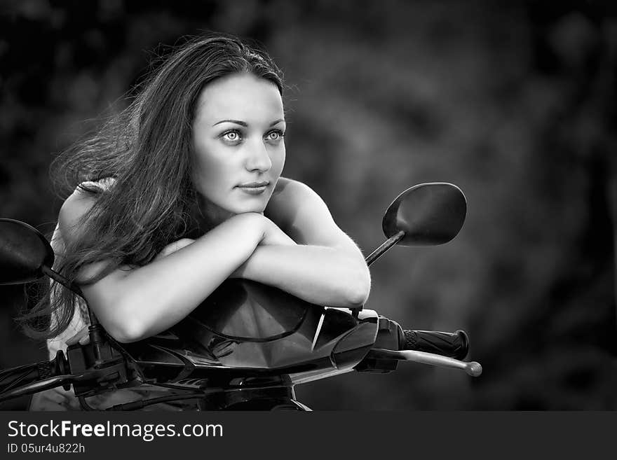 Beautiful woman thinking on a motorcycle. Beautiful woman thinking on a motorcycle