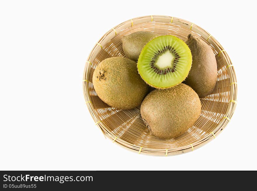 Whole kiwi fruit and his sliced segments isolated in basket, on white background cutout. Whole kiwi fruit and his sliced segments isolated in basket, on white background cutout