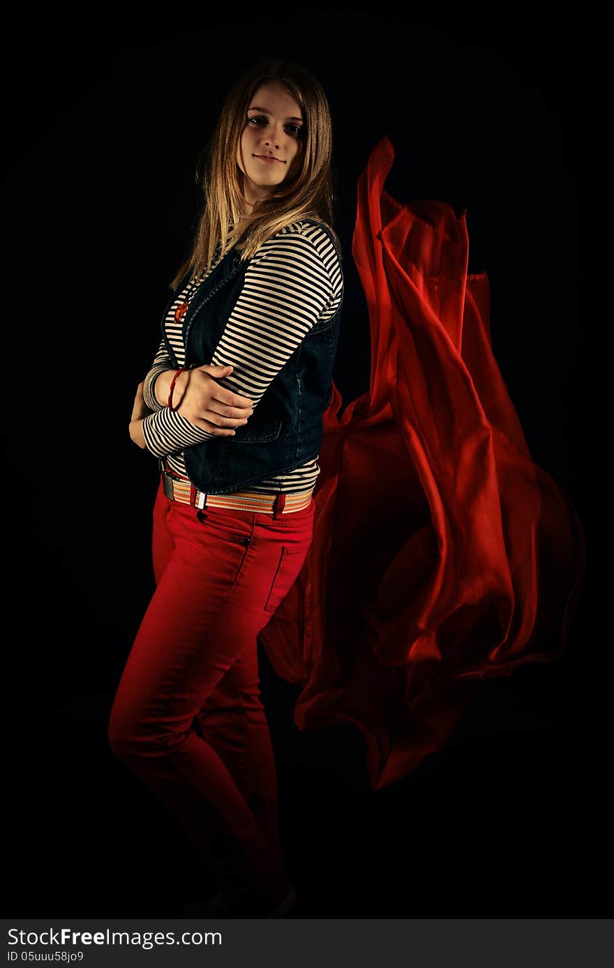 Beautiful Girl Against Red Fabric In The Dark