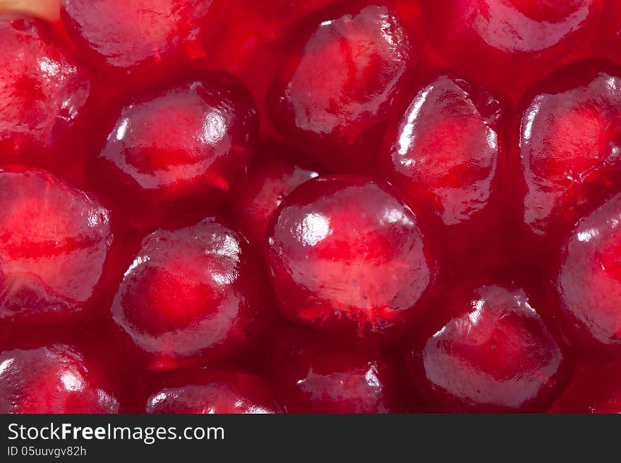 Juicy red pomegranate seeds - macro texture