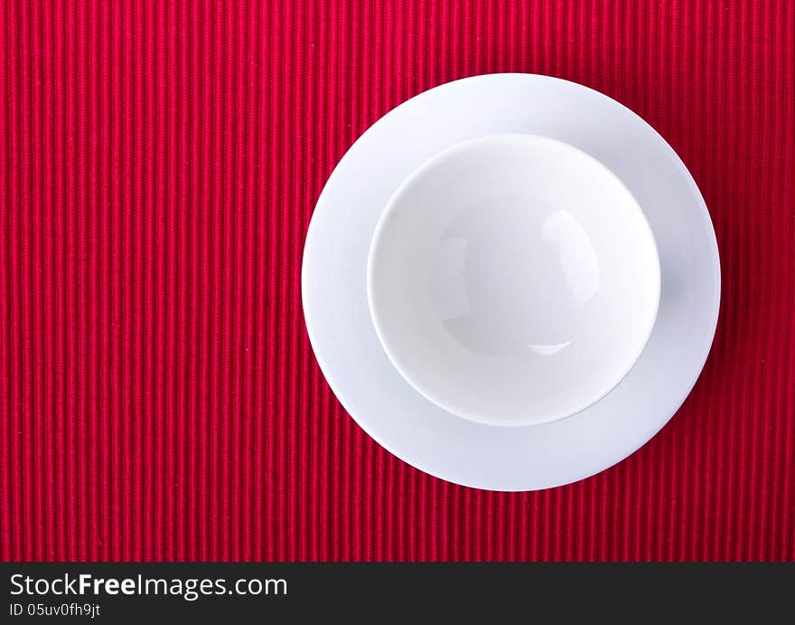 Empty bowl isolated on red background