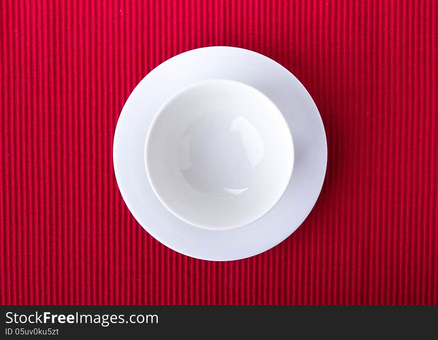 Empty bowl isolated on red background