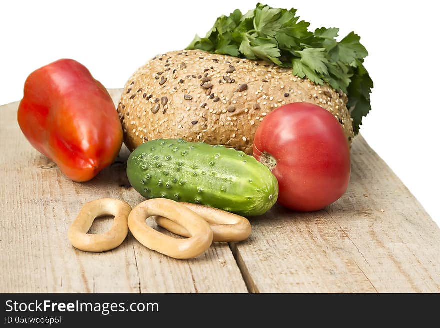 Bread tomato pepper drying bagels seeds sesame salad parsley green buffet wooden board grass beige red yellow orange agriculture isolated white background. Bread tomato pepper drying bagels seeds sesame salad parsley green buffet wooden board grass beige red yellow orange agriculture isolated white background