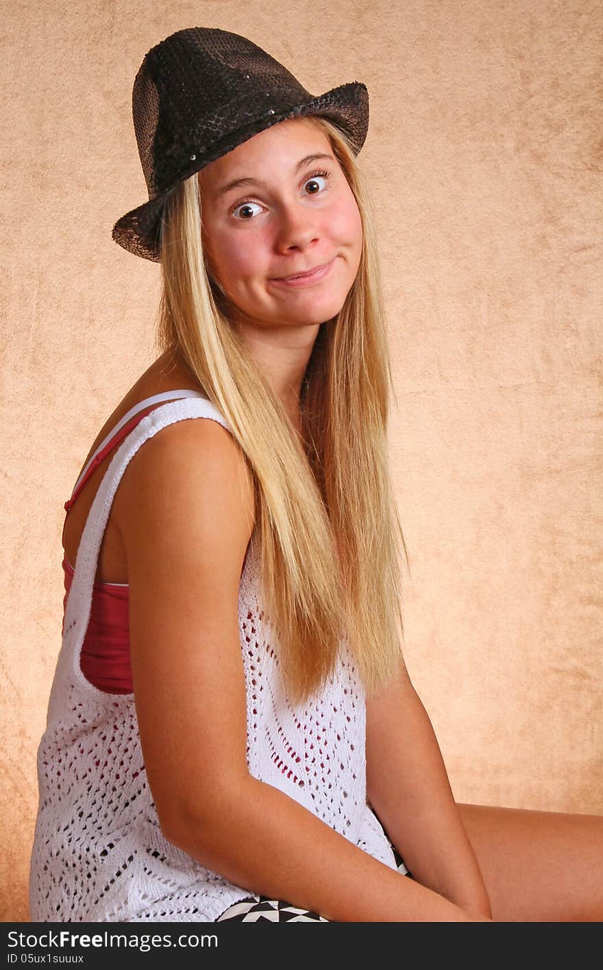 Teenage Female With Black Hat And Silly Expression. Teenage Female With Black Hat And Silly Expression