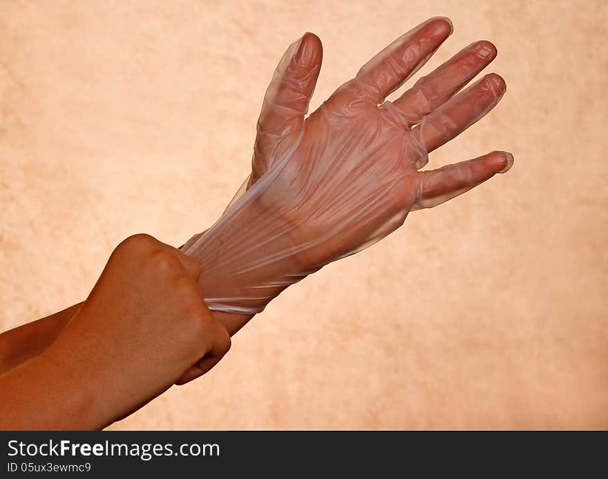 Woman's Hand Pulling On Rubber Glove. Woman's Hand Pulling On Rubber Glove