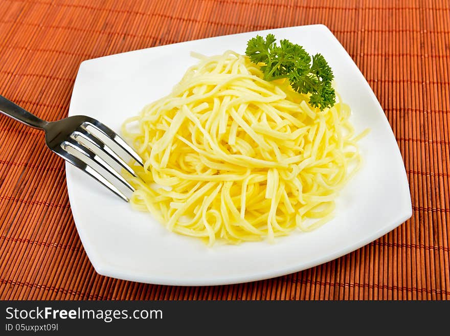 Italian egg pasta on plate with fork