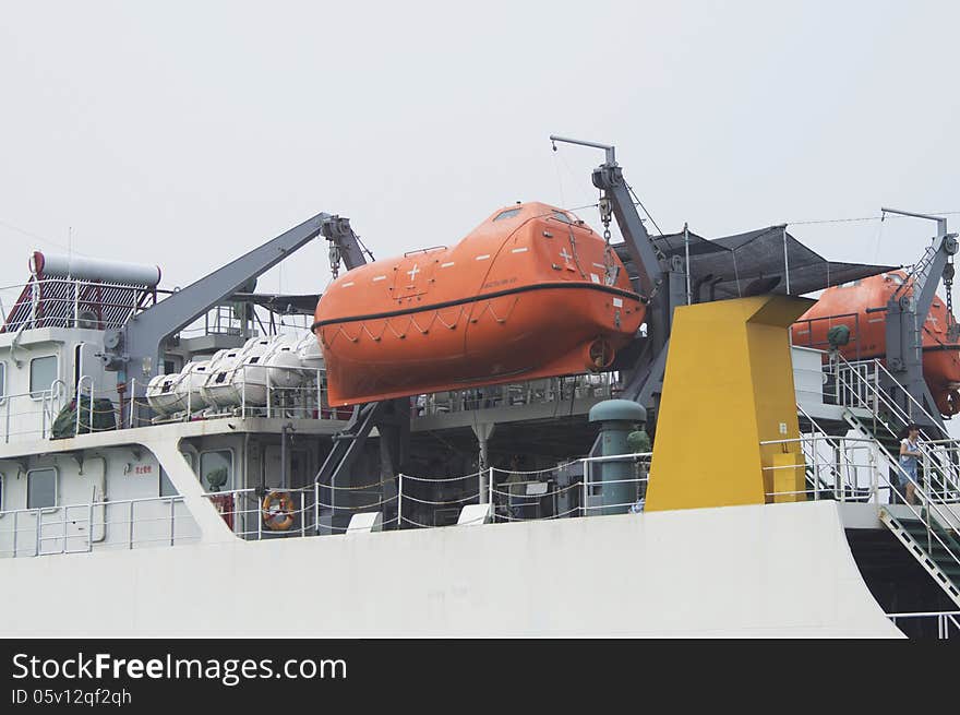 Lifeboat on a davit at a modern ferry ship. Lifeboat on a davit at a modern ferry ship