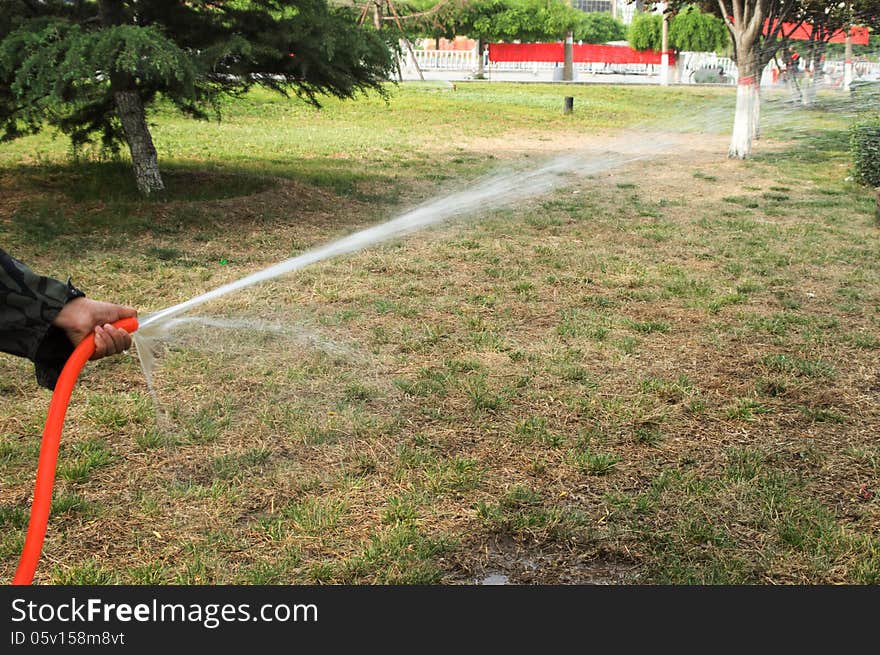 The water sprinkler in garden. The water sprinkler in garden