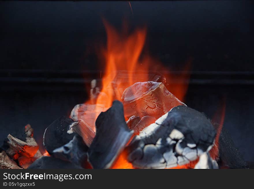 Charcoal grill and a bright flame in BBQ facilities. Charcoal grill and a bright flame in BBQ facilities.