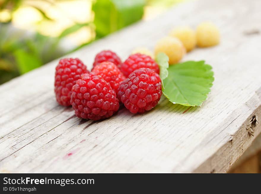 Still-life from white and red raspberries in the form of a flower with a leaf strawberry. Still-life from white and red raspberries in the form of a flower with a leaf strawberry.