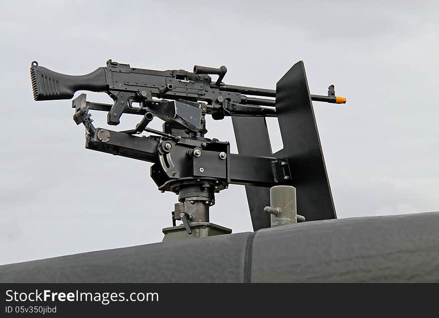 A Machine Gun Mounted on the Top of a Military Vehicle. A Machine Gun Mounted on the Top of a Military Vehicle.