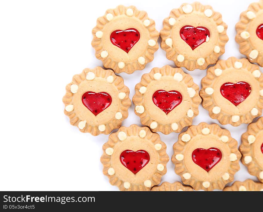 Heart shaped strawberry biscuit on a white background. Heart shaped strawberry biscuit on a white background.