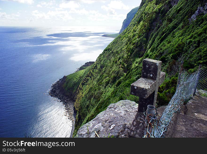 Wild coast and ancient stone cross