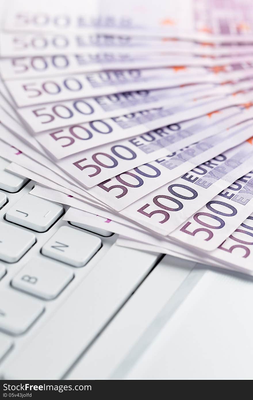 Online banking, European paper currency on the computer keyboard