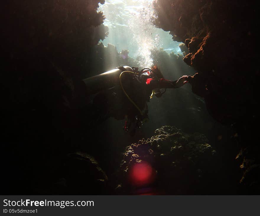 Diver Exploring Cave