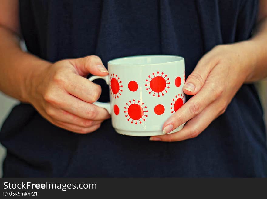 Hands of a woman holding a cup. Hands of a woman holding a cup