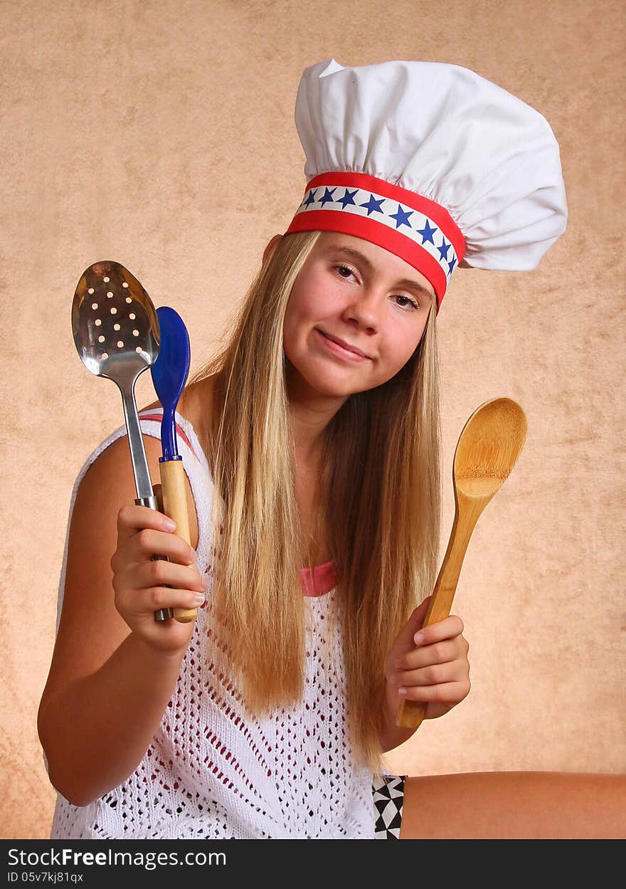 Teenage Female With Bakers Hat Cooking Utensils. Teenage Female With Bakers Hat Cooking Utensils