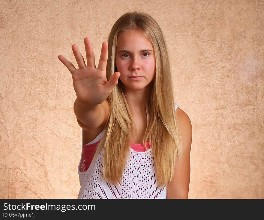 Teenage Female Holding Open Hand Toward Viewer. Teenage Female Holding Open Hand Toward Viewer