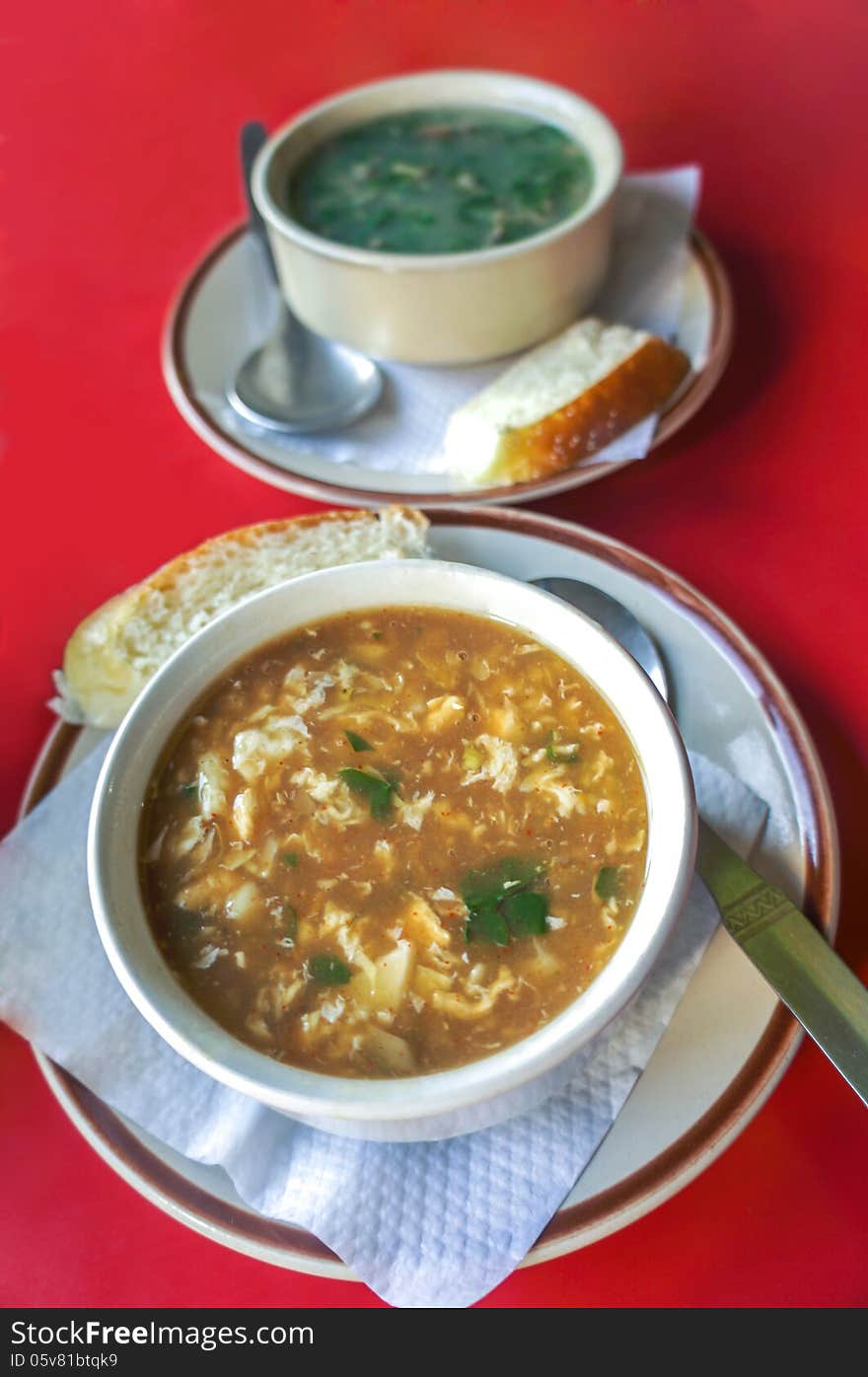 Sour cream soup and spinach soup served with bread