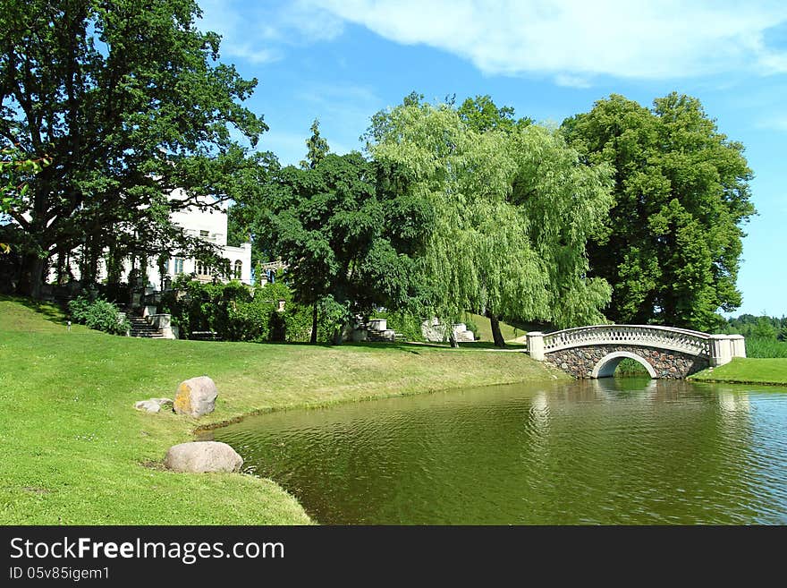 Vintage stone bridge on the lake in green park. Vintage stone bridge on the lake in green park