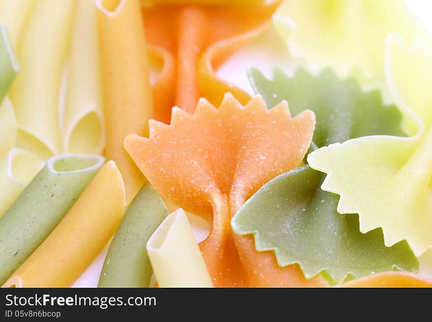 Different pasta in three colors. Macro. Background.