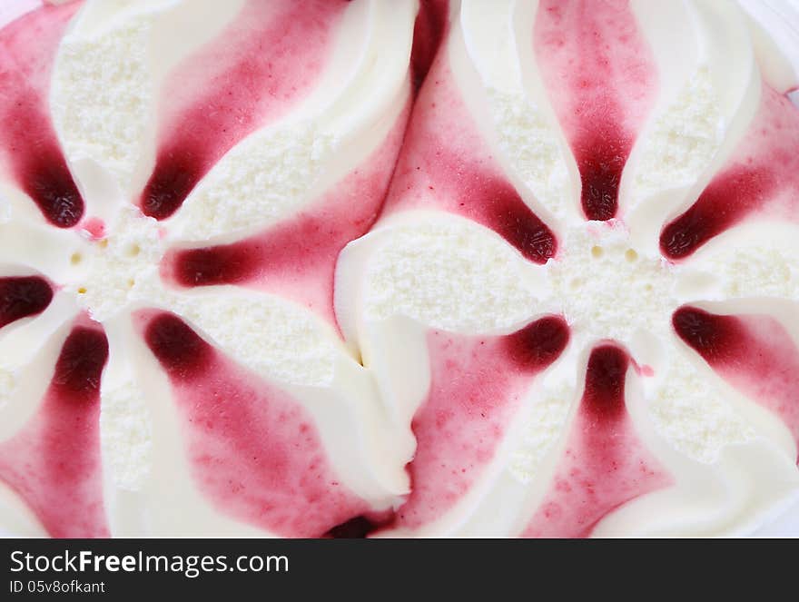 White ice cream shaped star and red syrop. Bacground.