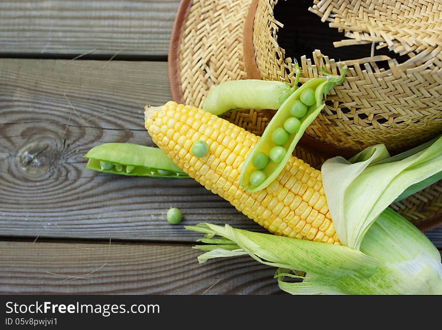 Abstract rural still life with green peas, corn, wheat and straw hat. Abstract rural still life with green peas, corn, wheat and straw hat