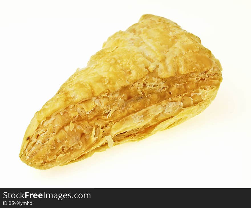 Piece of delicious puff on white background