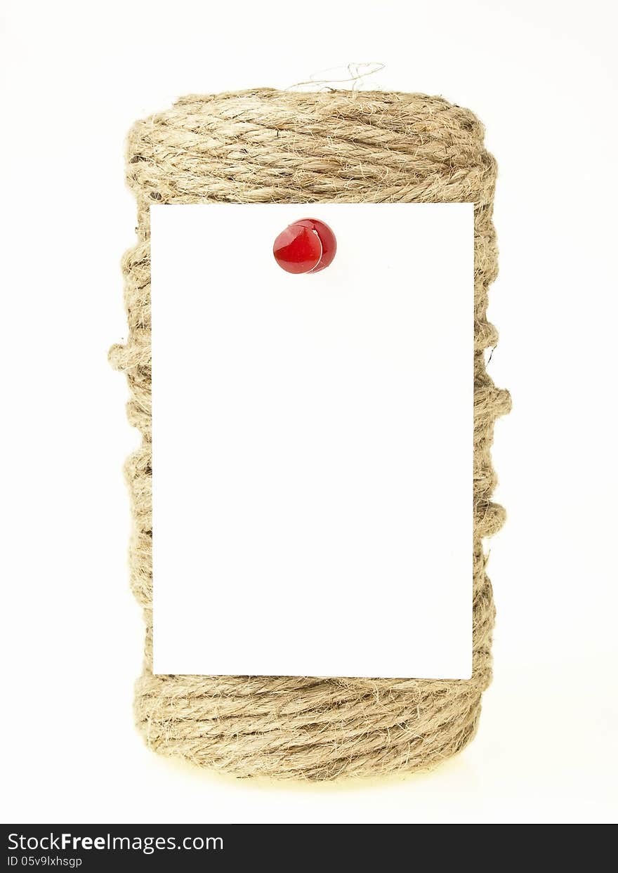 White paper note pin on hemp rope roll. White paper note pin on hemp rope roll