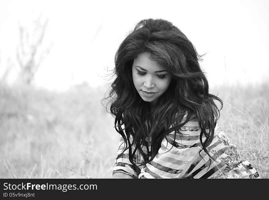 Black and white portrait of an attractive young woman with long blac hair.