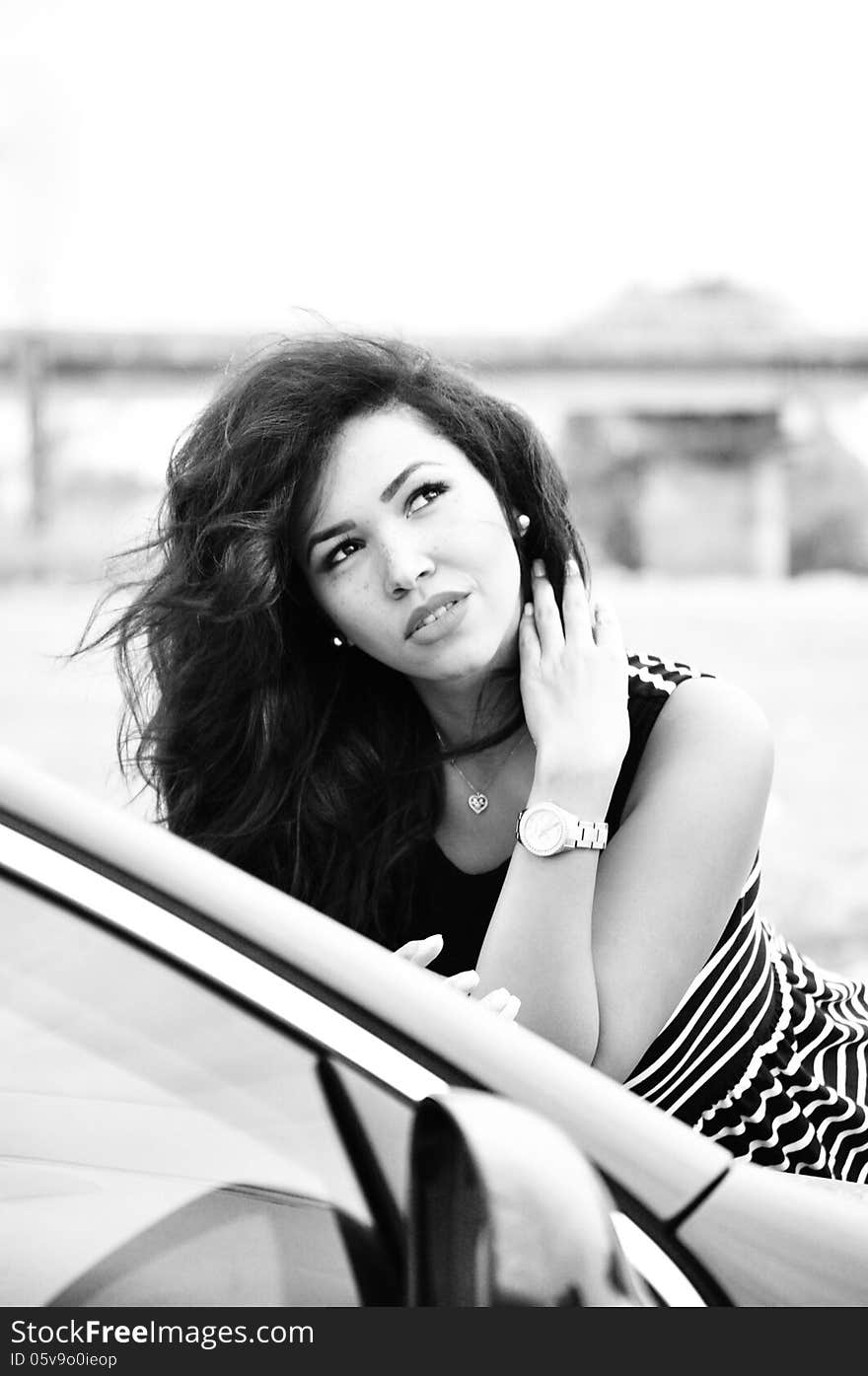 Black and white portrait of an attractive young woman with long blac hair.