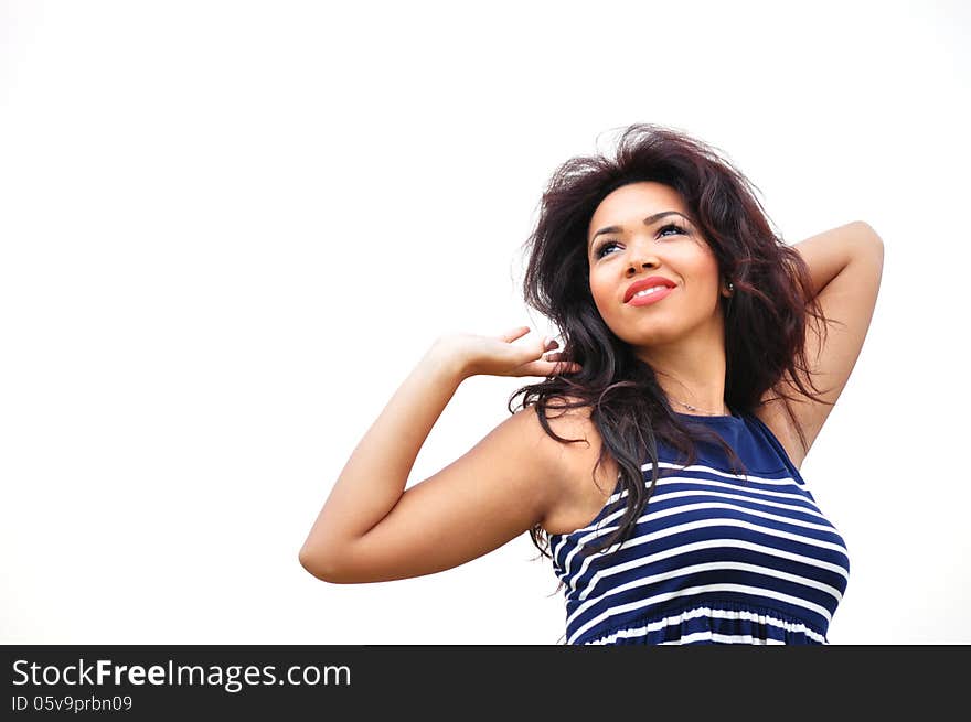 Outdoor portrait of an attractive young woman with long blac hair.