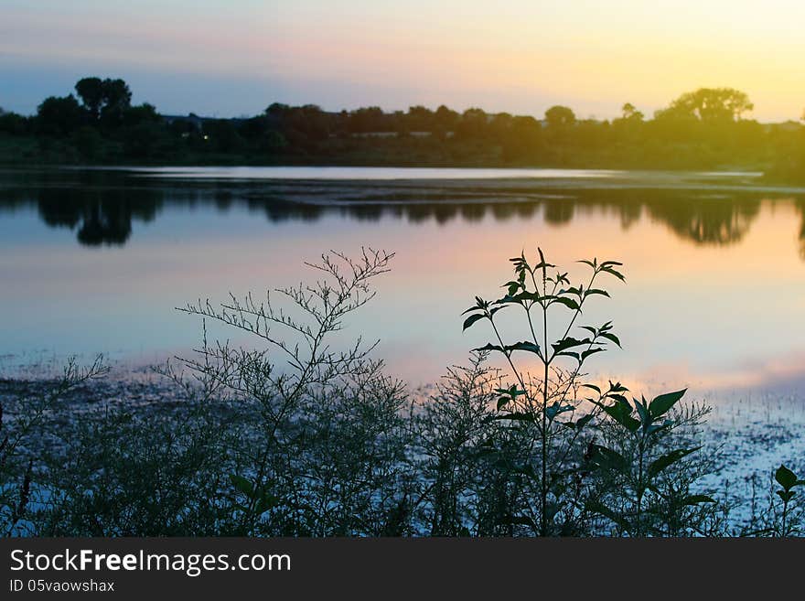 Dramatic sunset over the lake in the park.