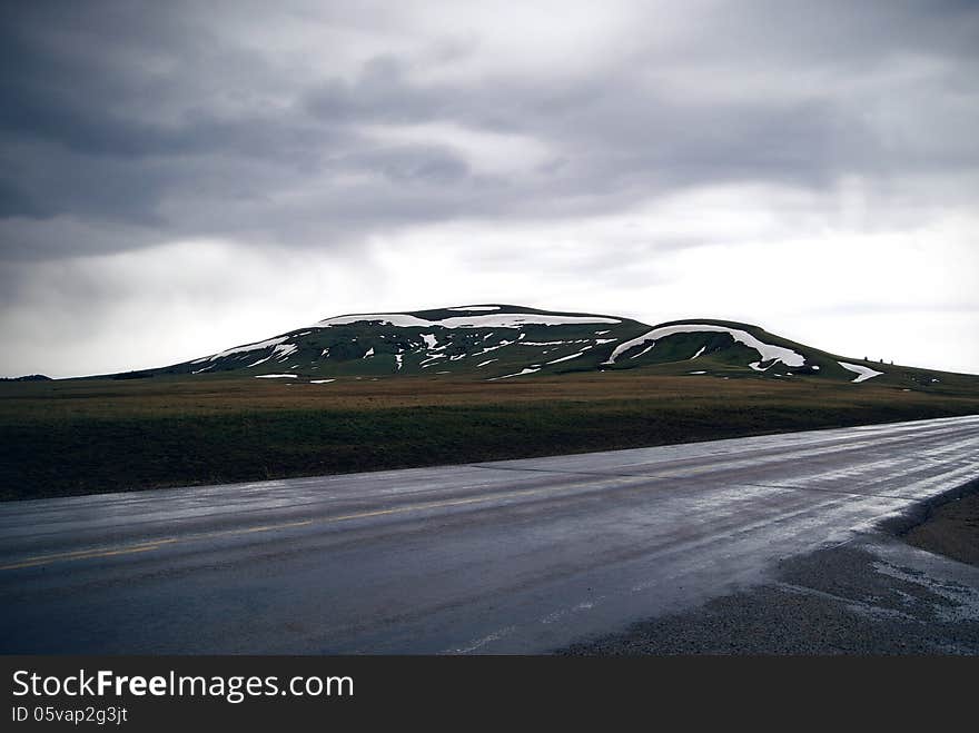 Beautiful mountain landscape with wet road