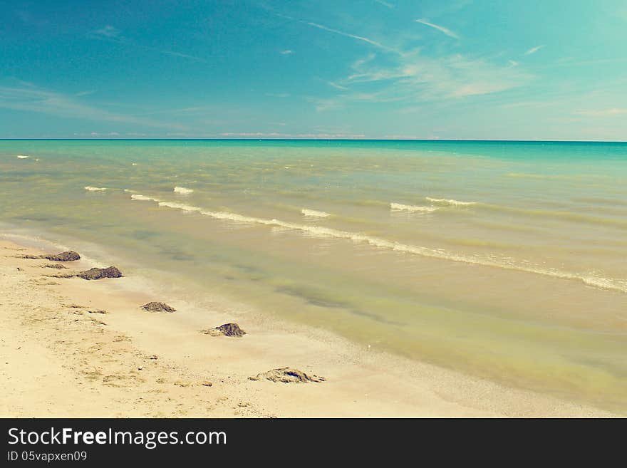 Summer view calm sea water on sand beach and blue sky