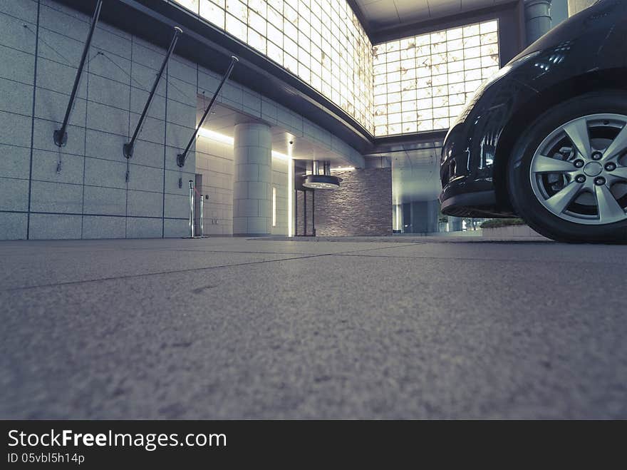 Urban night parking with front car wheel fragment