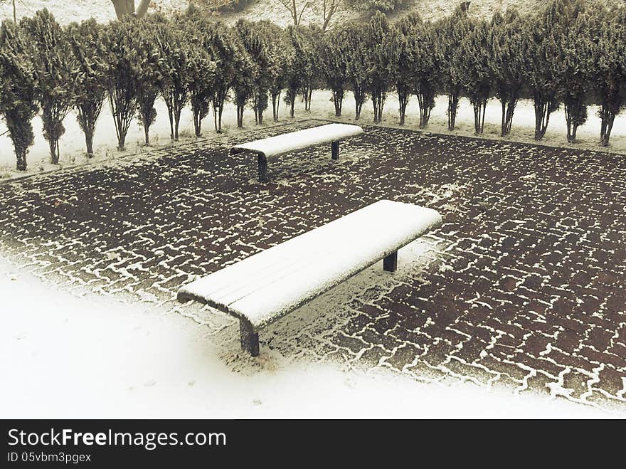 Two benches under fresh snow in city park. Two benches under fresh snow in city park