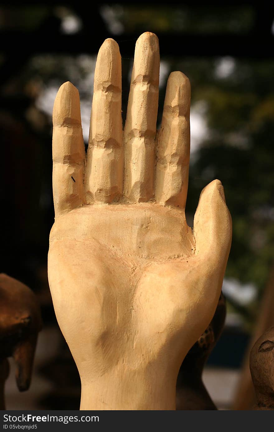 African carved hand indicating STOP, warning or - to some cultures - greeting. African carved hand indicating STOP, warning or - to some cultures - greeting.