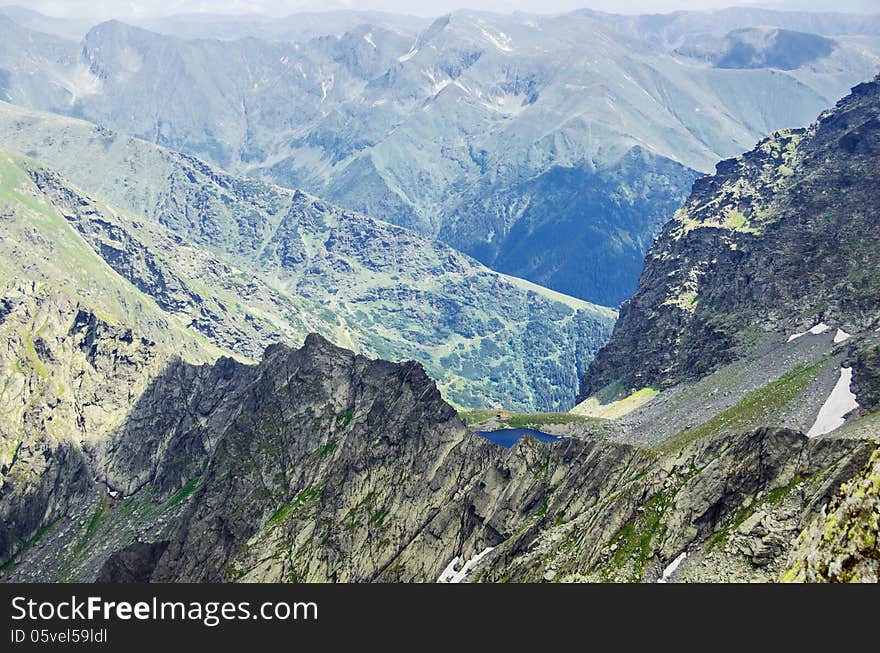 Over the clouds - view from Mount Negoiu of Caltun Lake, Fagaras Mouintains. Over the clouds - view from Mount Negoiu of Caltun Lake, Fagaras Mouintains.