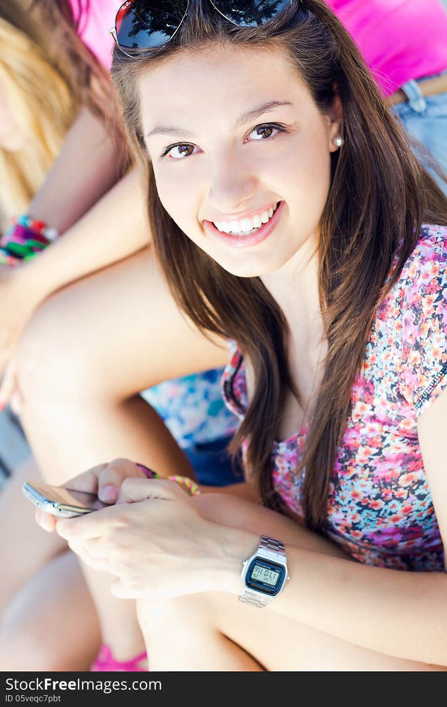 Pretty Young Girl Chatting With Smartphone