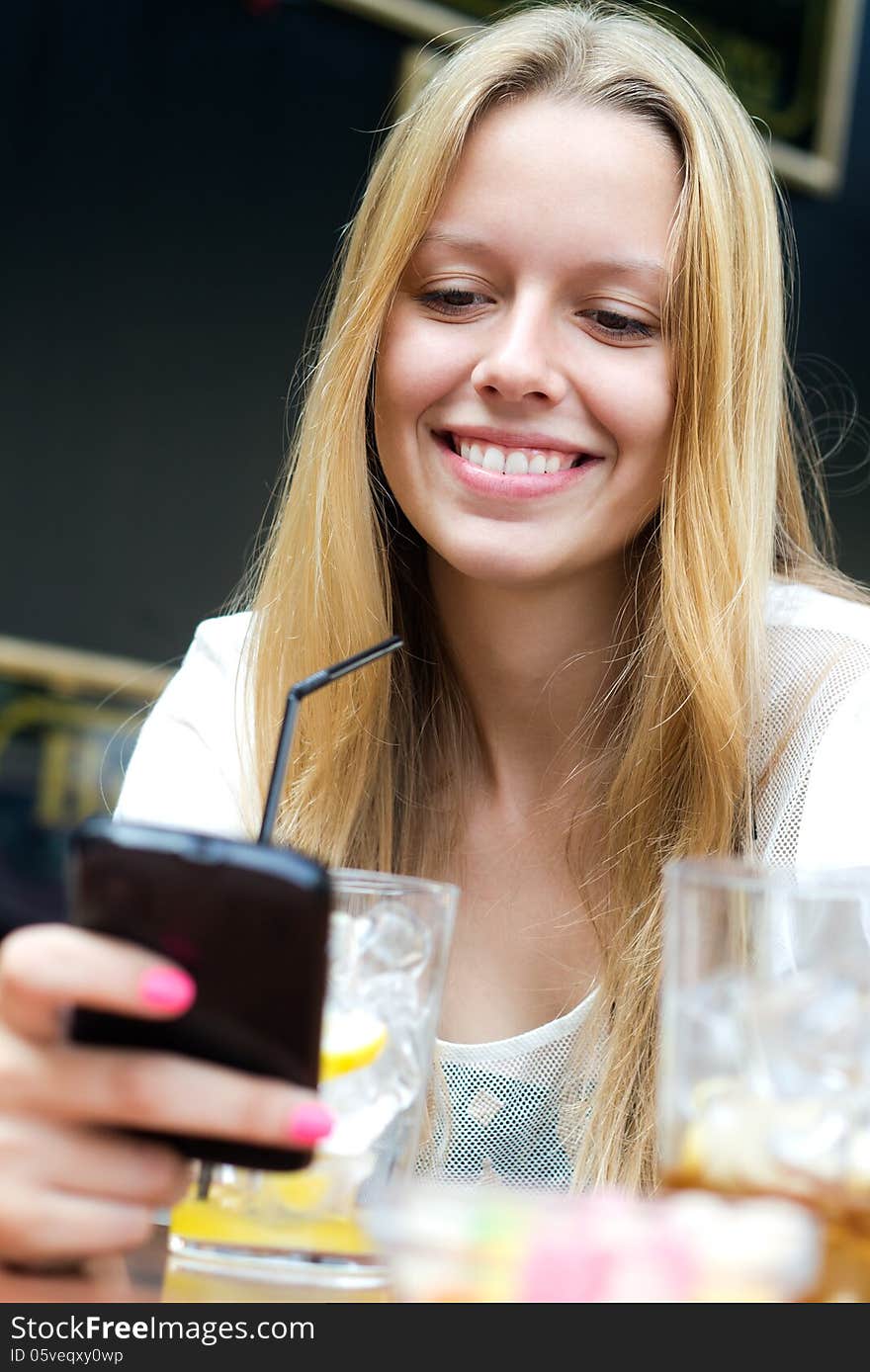 Pretty young girl chatting with smartphone