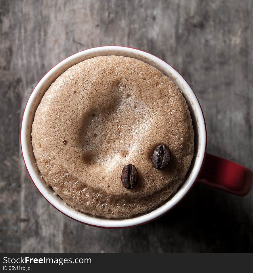 Cup of espresso with coffee beans, close up