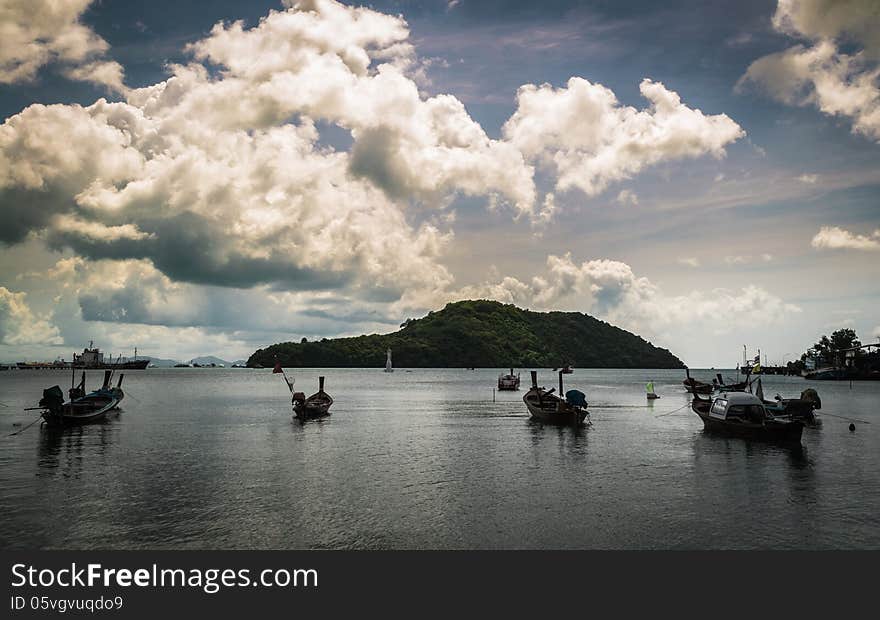 Many fishing boat on the sea with cloudy sky in the morning